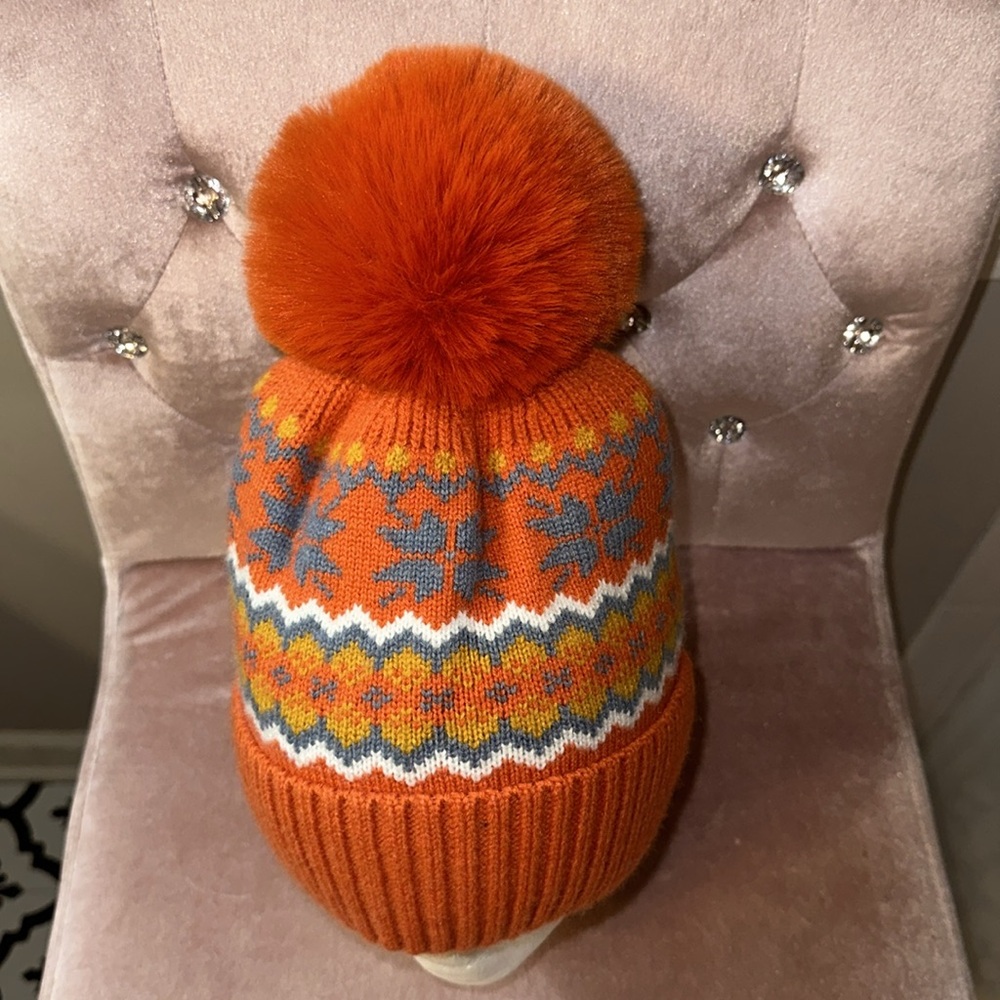 NWOT hat with extra large pompom in orange. OSFA